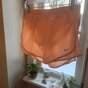 Orange Nike shorts.
